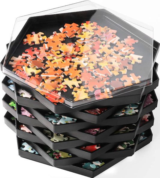 Stacked jigsaw puzzle sorting trays with jigsaw puzzle pieces sorted in each stacked tray