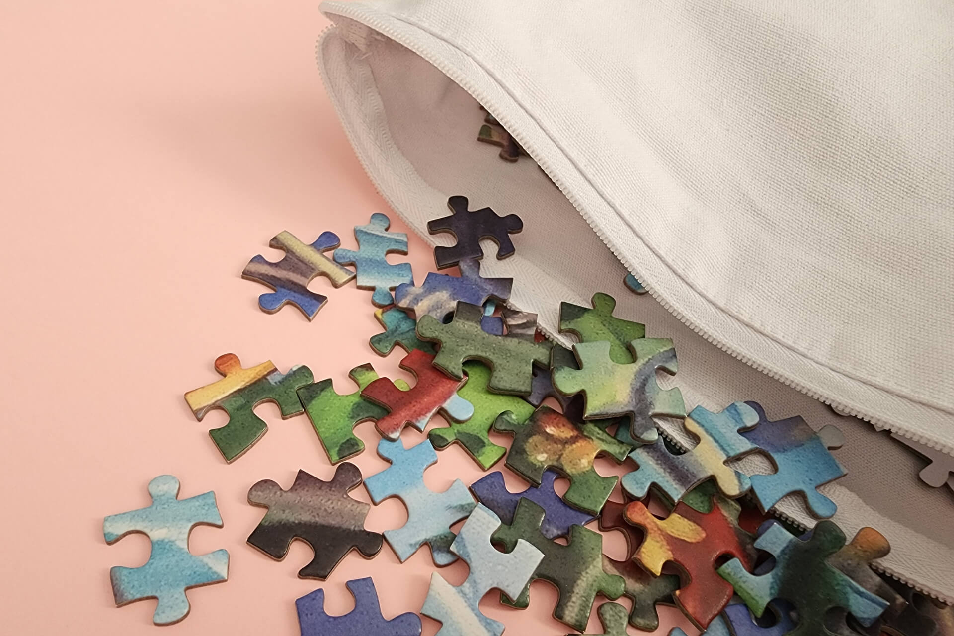 Jigsaw puzzle pieces coming out of white canvas bag